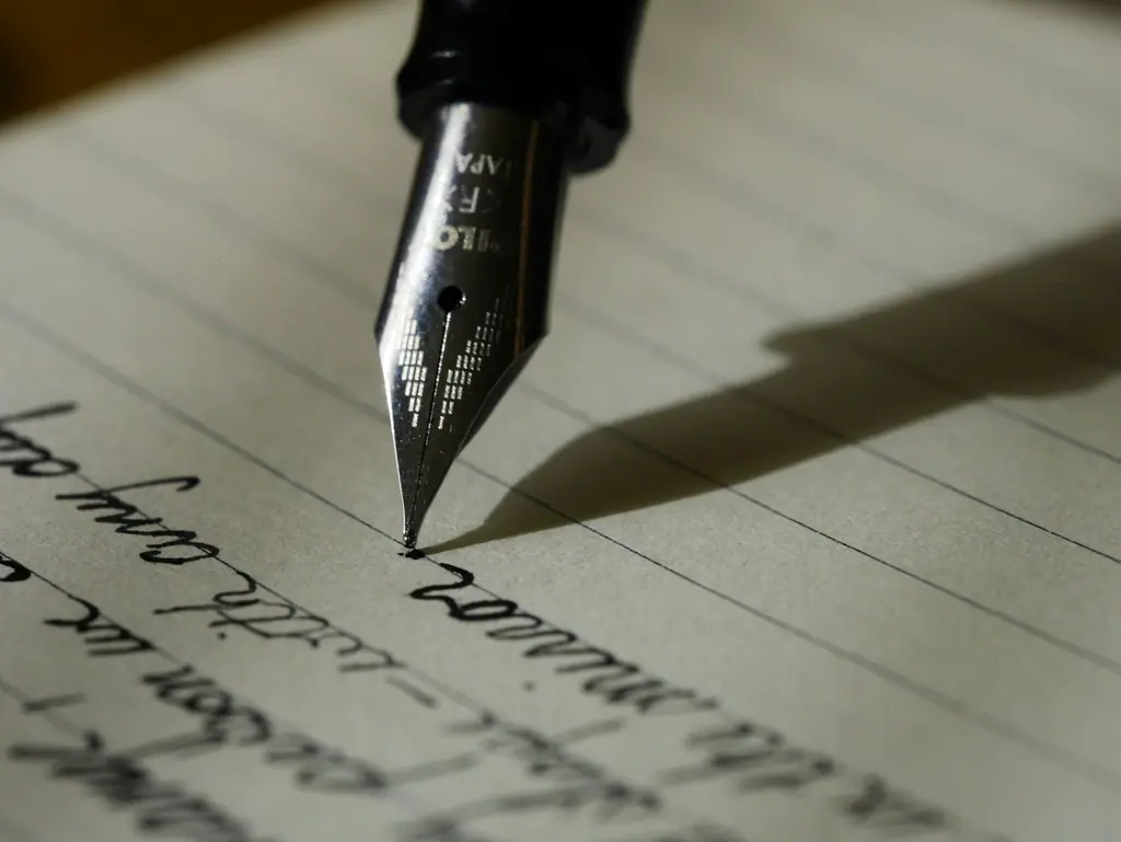 Fountain pen nib writing on paper, representing SEO copywriting that ranks and converts